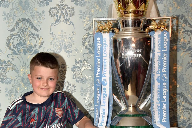Gino McCann (10) was happy to pose with the EPL Trophy when it visited Charlie McKeever's Bar last week. INPT18-209.