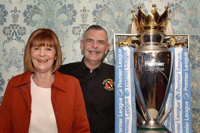 Joan Groves poses with McKeever's barman, Stephen Lavery beside the EPL Trophy when it visited the pub last week.INPT18-212.