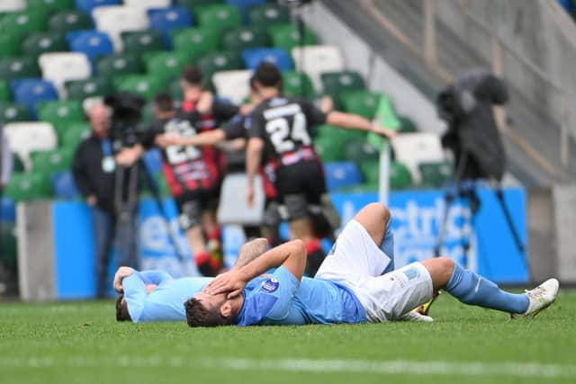 Ballymena United players are dejected after Johnny McMurray’s winner for Crusaders