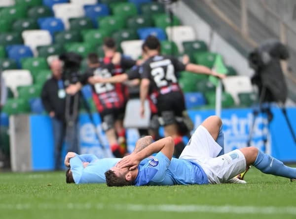 Ballymena United players are dejected after Johnny McMurray’s winner for Crusaders