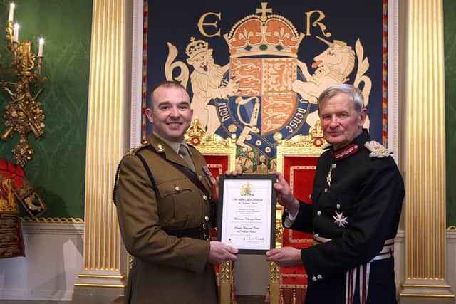Captain Thomas Dunlop receives award and congratulations from Mr David McCorkell, Her Majesty's Lord Lieutenant for County Antrim