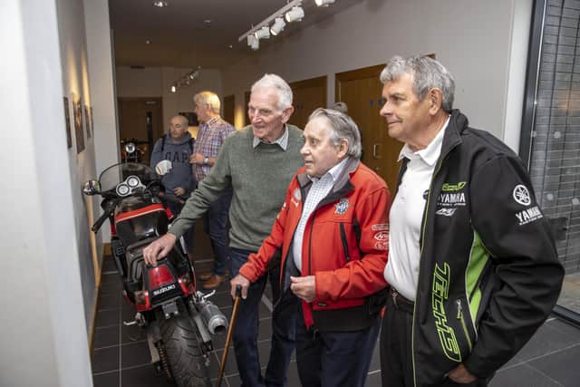 Famous past NW200 racers, two-time winner Dick Creith (left) and Len Ireland (centre), reflect over the new photographic exhibition at Roe Valley Arts and Cultural Centre, which features historic images taken from the book the ‘NW200 90th Road & Race’, by Ian Foster