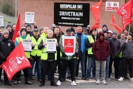 Caterpillar NI employees and Unite union members form a picket at the company's west Belfast plant on April 11. Picture: Jonathan Porter/PressEye.