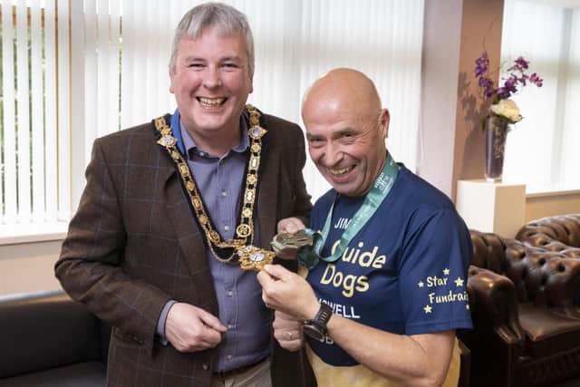 Jim Bradley and the Mayor of Causeway Coast and Glens Borough Council, Councillor Richard Holmes share a laugh as they compare chains and medals during the reception at Cloonavin