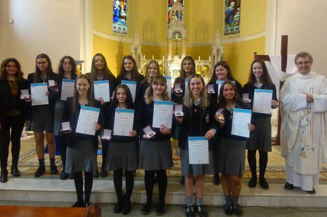 Dominican College pupils who were awarded their John Paul II gold awards pictured at Star of the Sea Church in Portstewart with school chaplain Fr Raymond McCullagh