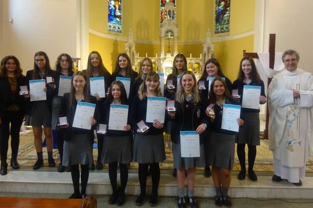 Dominican College pupils who were awarded their John Paul II gold awards pictured at Star of the Sea Church in Portstewart with school chaplain Fr Raymond McCullagh