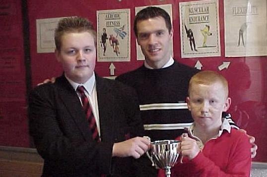 Noel Hutchinson and Turlough Kelly (Player of the Tournament) from Our Lady of Lourdes High School, Ballymoney, who won the NEELB I.F.A. Under 18 Regional Tournament  2007 for the Learning Resources Centre at Ballymena Showgrounds back in 2007.  Included is Our Lady of Lourdes teacher and team manager Mr Liam Kearney.  The tournament was hosted by Alan Crooks and ex-Northern Ireland and Manchester United player Mal Donaghy