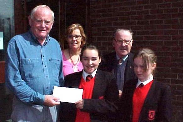 Paddy Reilly, Chairman of Ballymoney St Vincent de Paul receiving a cheque from Our Lady of Lourdes pupils, Danielle McErlain and Lyndsey McGuigan back in 2007. Looking on are Maire Buckley, (Charities Co-ordinator at OLOL ) and Brendan Smyth, (St Vincent de Paul)