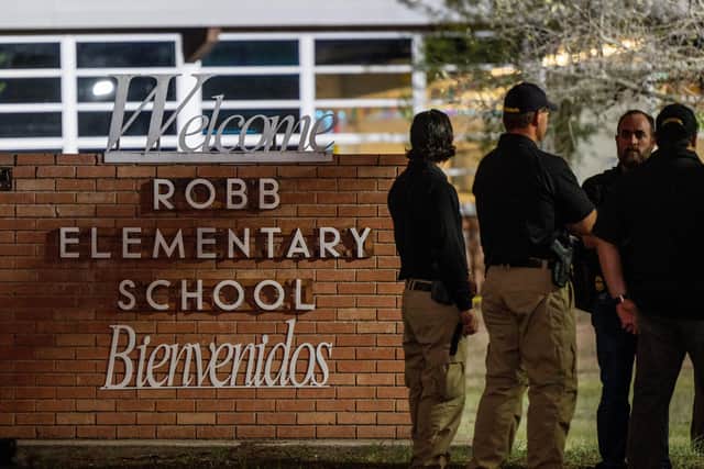 UVALDE, TEXAS - MAY 24: Law enforcement officers speak together outside of Robb Elementary School following the mass shooting at Robb Elementary School on May 24, 2022 in Uvalde, Texas. According to reports, 19 students and 2 adults were killed, with the gunman fatally shot by law enforcement. (Photo by Brandon Bell/Getty Images)