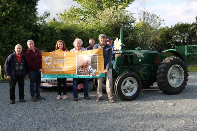 Members of the Dromara Vintage and Classic Club with Cancer Fund For Children representative Jordana Stoney-Wilson (from left) Peter McGrady, Gerard McGrillen, Griff Morrow, James Fegan, Brian McGrillen and Davy Thompson at last weeks launch of the charity tractor run.