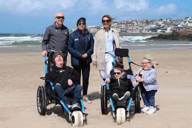 (Back row) Chris Thompson from the National Trust; Alix Crawford, Chairperson for the Mae Murray Foundation and Anna Corry of Blossoming Birds joined (front row) Conor O’Kane, a facility user and board member of the Mae Murray Foundation and Saul Wilton and his mum Jane Stewart as it is announced that Portstewart is now an Inclusive Beach following a fundraising campaign, led by Anna Corry.
