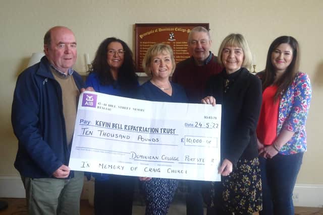 Colin and Eithne Bell receiving a cheque for £10,000 from members of the Church family and Dominican College principal Rosemary Ronan