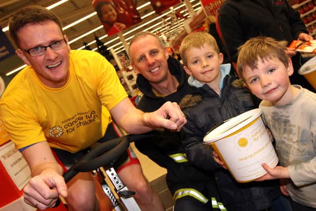 Michael Waring (left) and Noel McKee were part of a Northern Ireland Fire and Rescue Service team that took part in a 24-hour spin cycle challenge a number of years ago, included are Noel's sons Tom and Cameron, who were seven and five years of age respectively at the time.