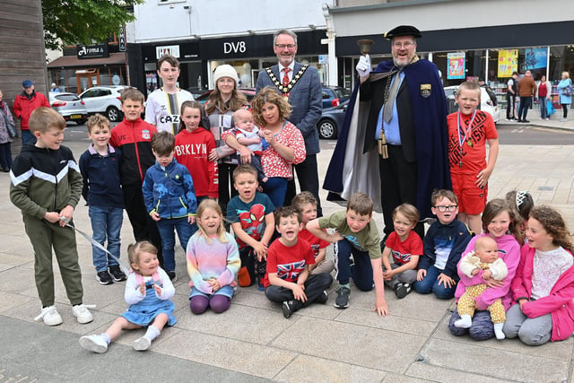 The Mayor of Mid and East Antrim, Councillor William McCaughey, with Town Crier Alderman Paul Reid and local children at Broadway in Larne.