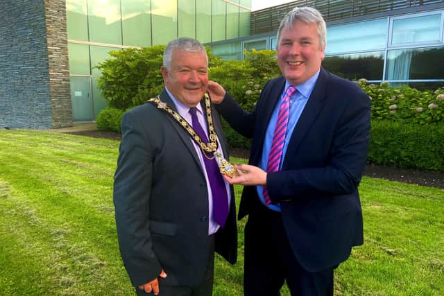 Outgoing Mayor Cllr Rochard Holmes presents the chain of office to the new Mayor of Causeway Coast and Glens Borough Council, Cllr Ivor Wallace