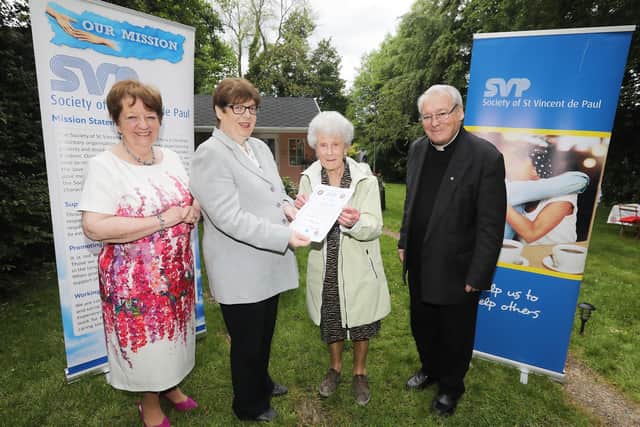 Mary Waide, Regional President of SVP North Region, Rose McGowan, SVP National President and Fr Perry Gildea, congratulate Annette McWilliams of SVP Blessed Virgin, Ballymena, on more than 25 years volunteering with St Vincent de Paul