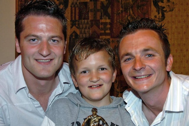 Coagh Youth U13 Most Improved Player of the Year James McIver receives his award from coaches Ally McGuckin and Andrew Creighton in 2007.