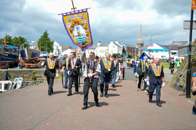 Members of the Orange Order step out along the parade route. Picture: 
Andrew McCarroll/ Pacemaker Press