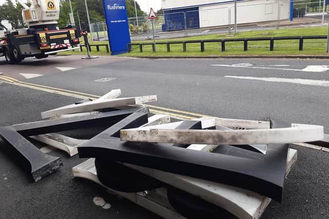 The old Debenhams sign at Rushmere Shopping Centre in Craigavon, Co Armagh is removed by workmen today.