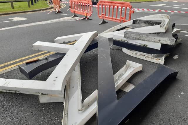 The old Debenhams sign at Rushmere Shopping Centre in Craigavon, Co Armagh is removed by workmen today.