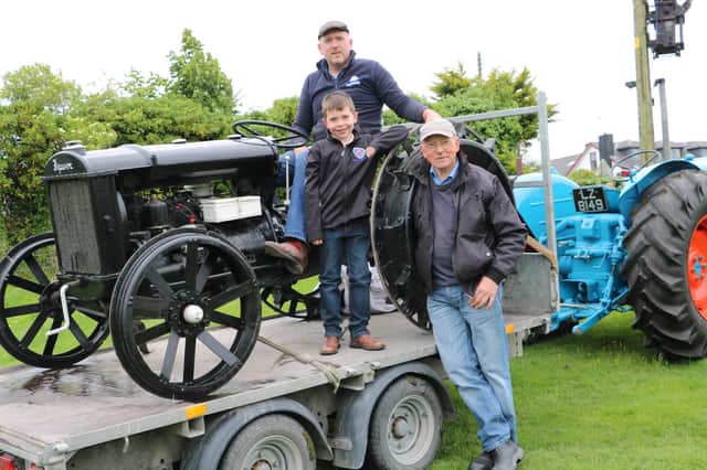 One of the rarest pieces of machinery on display at last week's Dromara Tractor Run in aid of the Daisy Lodge centre for children with cancer was this 1936 Ferguson Brown tractor. Daniel Flynn is in the driving seat accompanied by his nephew Jack Glass and Claragh Bridge Show committee member Paddy Murray.