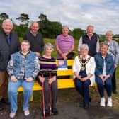 Deputy Mayor of Mid & East Antrim, Beth Adger and Marjorie Hawkins, Chair of the Mi&East Antrim Loneliness Network with Ahoghill in Bloom volunteers James Perry, Sarah Perry, Wallace Elder, Sandra Moore, John Wilson, John Small and Patricia Perry, at the launch of the Ahoghill Chatty Bench.
