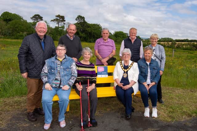 Deputy Mayor of Mid & East Antrim, Beth Adger and Marjorie Hawkins, Chair of the Mi&East Antrim Loneliness Network with Ahoghill in Bloom volunteers James Perry, Sarah Perry, Wallace Elder, Sandra Moore, John Wilson, John Small and Patricia Perry, at the launch of the Ahoghill Chatty Bench.