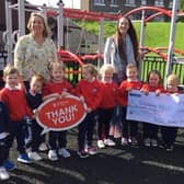 Mrs Helen Malcolm, Grace Williams (Area Fundraising Manager for Air Ambulance NI) and Principal Tracey Cassells with pupils from Barbour Nursery School