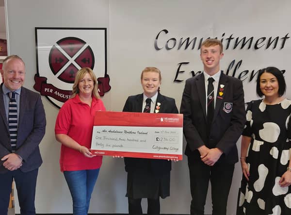 Cullybackey College Principal Mr David Donaldson at the hand over of a cheque for £1236 to Wendy Pickering (NI Air Ambulance) by Alix Ross - Head Girl and William Hammond - Head Boy, (Right) Mrs Pamela Surgenor