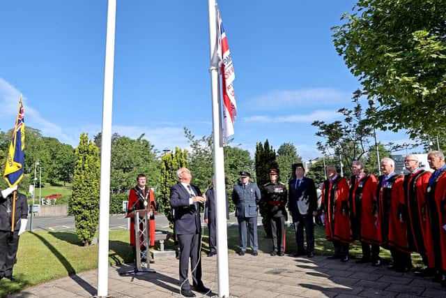 Deputy Lieutenant of County Antrim Eric Rainey raises the Armed Forces Flag at the Civic Headquarters of Lisburn & Castlereagh City Council.