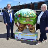 Mayor of Antrim and Newtownabbey Alderman Stephen Ross pictured with NI Hospice Chief Executive Heather Weir at the Council’s Elmer sculpture, beside the HMS Caroline at Belfast Harbour.