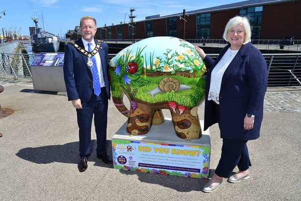 Mayor of Antrim and Newtownabbey Alderman Stephen Ross pictured with NI Hospice Chief Executive Heather Weir at the Council’s Elmer sculpture, beside the HMS Caroline at Belfast Harbour.