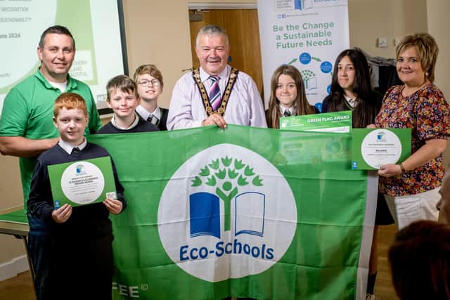 St Patrick's and St Brigid's PS receiving their Eco-Schools green flag from the Mayor of Causeway Coast and Glens Borough Council, Cllr Ivor Wallace