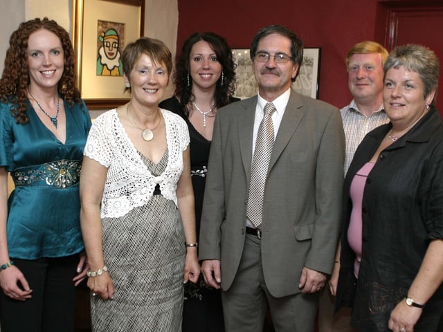 IN THE PAST. Ray O'Brien, pictured on Friday night along with Nuala Doran, (PTA) and staff from St Brigid's PS Ballymoney at a function on Friday night to mark Mr O'Brien's retirement after 21yrs.BM26-095SC.