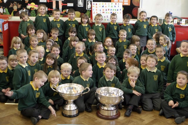 CUPS OF CHEER. Pictured on Wednesday are pupils from St Brigid's PS Ballymoney along with the Christie Ring and Ulster Championship cups won by Antrim.BM46-008SC.
