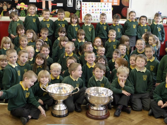 CUPS OF CHEER. Pictured on Wednesday are pupils from St Brigid's PS Ballymoney along with the Christie Ring and Ulster Championship cups won by Antrim.BM46-008SC.