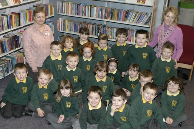 STORYTIME. Leah Tweed, (Ballymoney Library), pictured along with pupils from St Brigid's PS, Ballymoney, who received their Book Time packs on Thursday. Included is Teacher Miss Stewart.BM48-022SC.