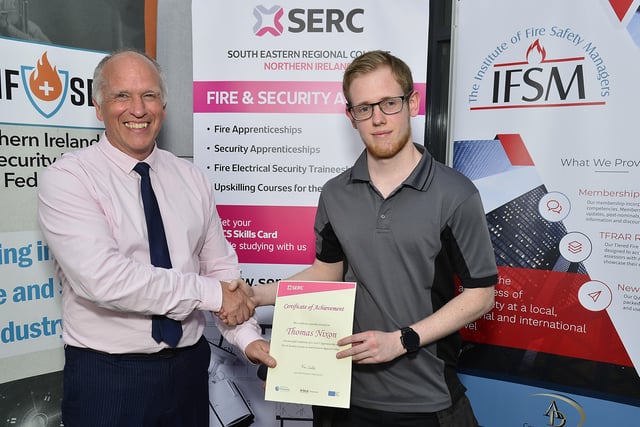 John Nixon, Head of School of Construction, Engineering Services and Skills for Work presents Recognition Certificate to first cohort Level 3 Fire Security Apprentice Thomas Nixon (Lisburn), Engineering Technician in Electrical, Fire & Security at SERC