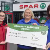 Karen Kerr, Project Manager and Jillian Kettley, Assistant Manager Listening Ear, being presented with £1,000 grant from Lee McMaster, SPAR store manager.