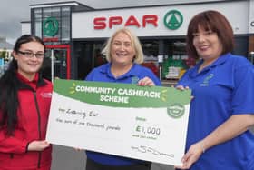 Karen Kerr, Project Manager and Jillian Kettley, Assistant Manager Listening Ear, being presented with £1,000 grant from Lee McMaster, SPAR store manager.