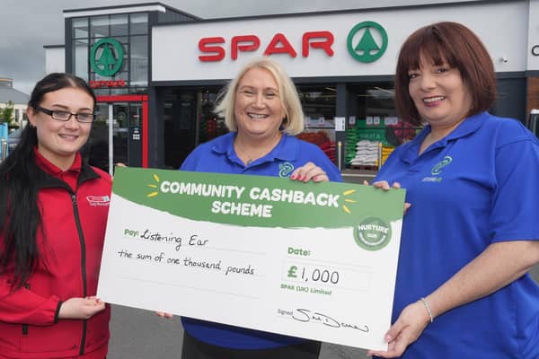 Karen Kerr, Project Manager and Jillian Kettley, Assistant Manager Listening Ear, being presented with £1,000 grant from Lee McMaster, SPAR store manager.