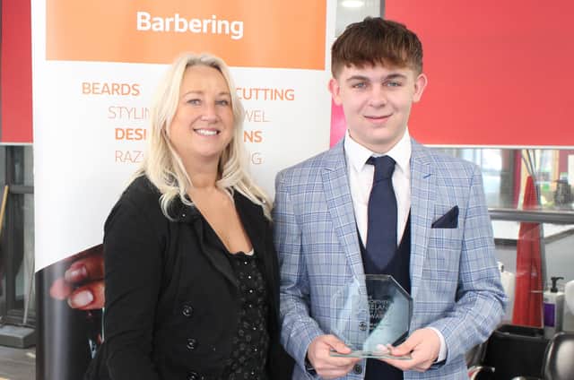 Sarah June Robinson, Lecturer in Hair and Barbering at the College’s Lisburn Campus pictured with Level 3 Barbering student Owen Andrews, 18, from Crumlin,  who scooped the Young Barber of the Year at the Northern Ireland Hair and Beauty Awards 2022