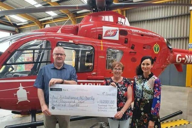 Johnston and Alison Gilmore presenting Kerry Anderson from Air Ambulance NI charity with a cheque for £6,200 from their Bluebell and Birdsong fundraiser