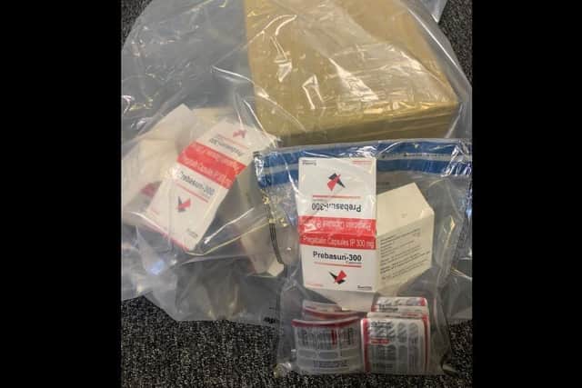 A number of items including cash, suspected class B & class C Drugs were seized after searches by the PSNI in Portadown, Co Armagh.
