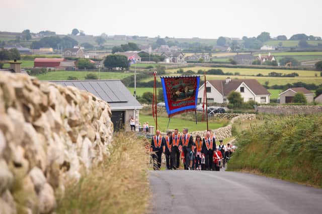 Members of Orangefield Flute Band along with members of Ballinran Orange Lodge step out on July 12 in 2021 in Kilkeel, Co Down close to the Mourne Mountains. Picture: Kelvin Boyes / Press Eye