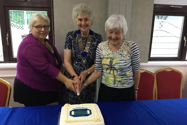 Executive Member, Susan Lyons, Kilrea WI President, Jennifer Gardiner and Vice- President, Margaret Bamford cut the special anniversary cake