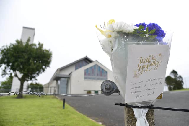 Flowers left at the scene were a man in his 30s died after an accident while helping to build the Antiville bonfire in Larne. Picture : Pacemaker Press