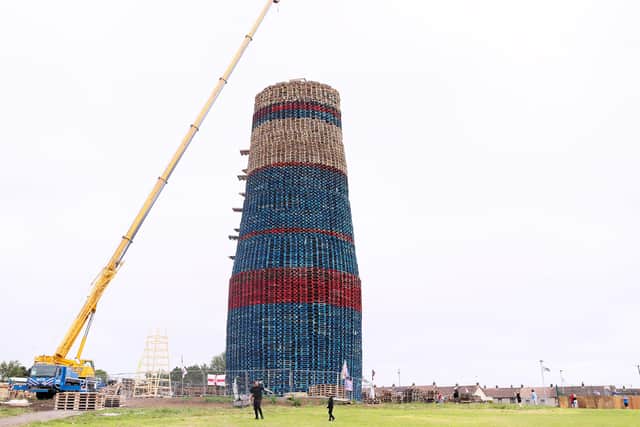 Bonfire builders use a crane to set down the final part to the structure.

Picture: Jonathan Porter/PressEye