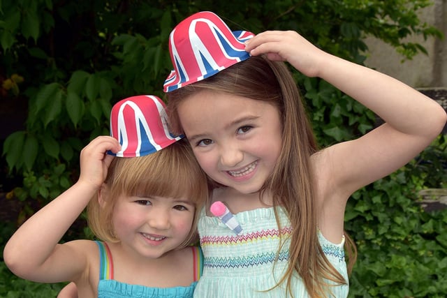 Hats Off...Betsy Holden (3) and sister Martha (6) wearing the corrrect headgear for the big parade. PT28-217.