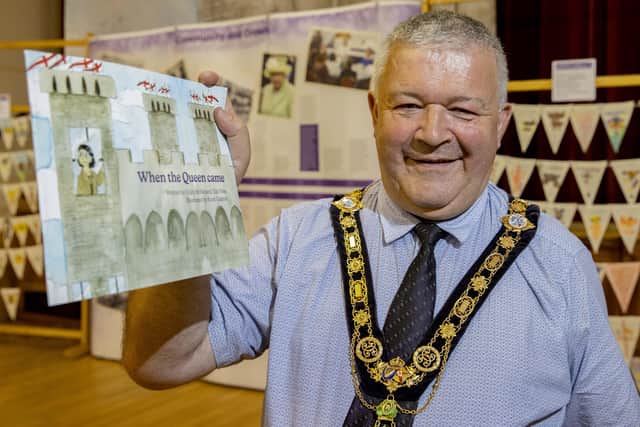 The Mayor of Causeway Coast and Glens Borough Council Councillor Ivor Wallace pictured with the new children’s storybook ‘When the Queen Came’ created as part of the Council’s Jubilee programme